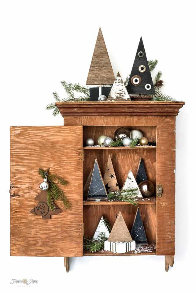 Scrap wood Christmas trees in a vintage cabinet,  thrift store makeovers.