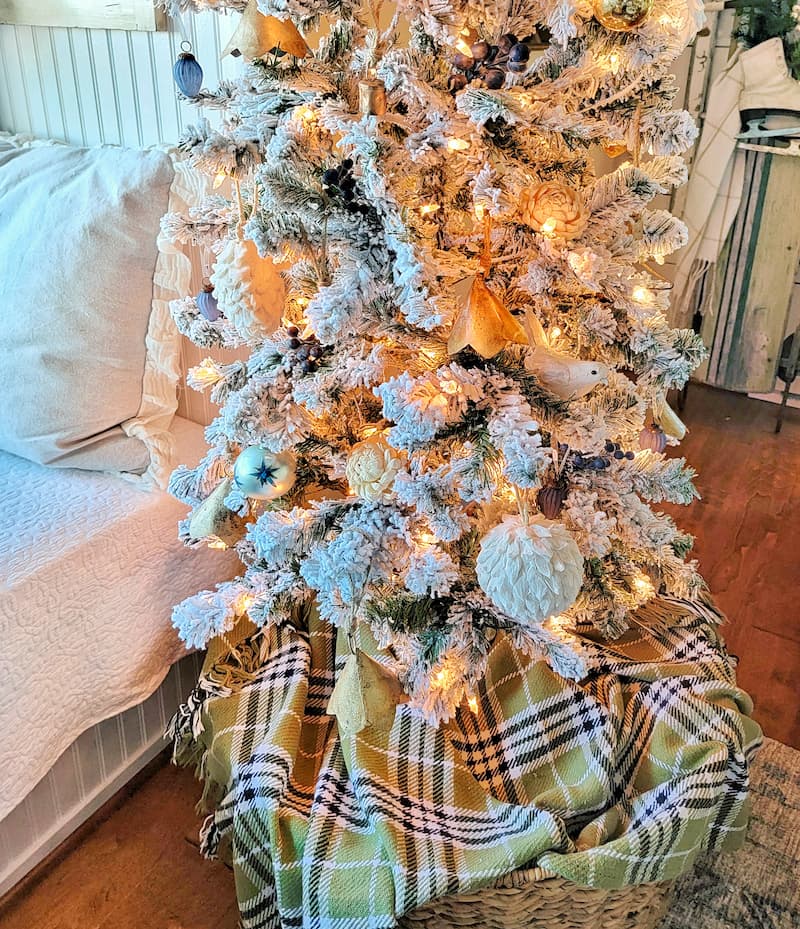 Plaid thrifted blanket as Christmas tree skirt for thrifted Christmas decor ideas.