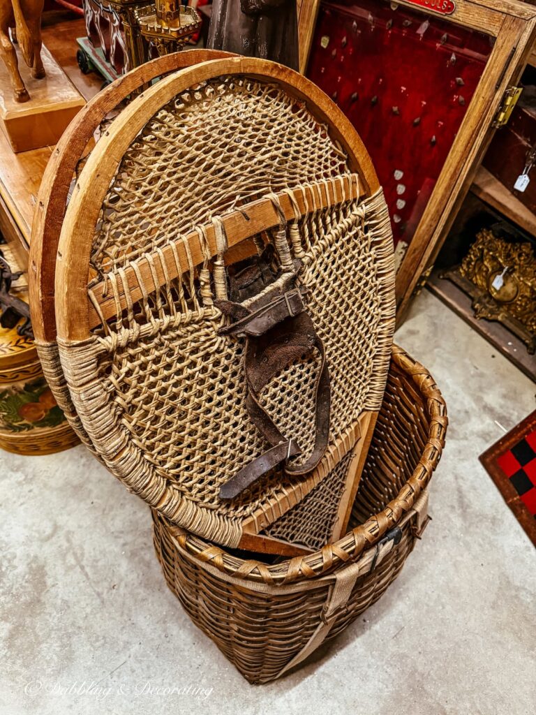 Bear Claw antique snowshoes in a basket at an antique store in Vermont.