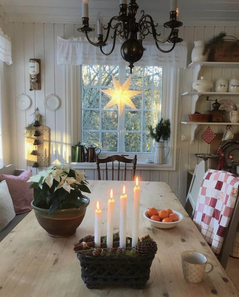 Cozy home in Sweden with star in window with lit candles and dining room table.