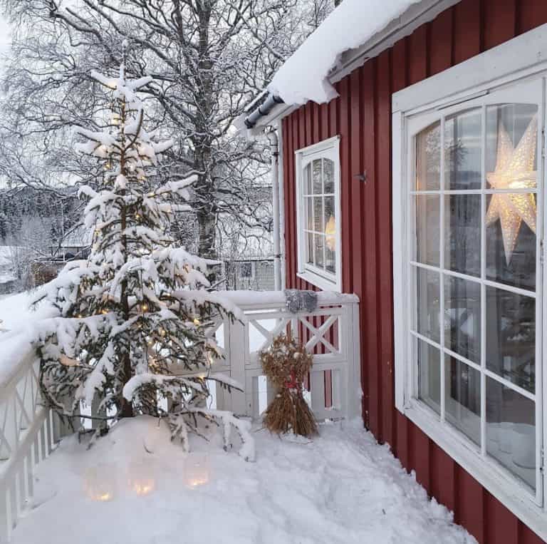 Christmas Tree on Porch of home in Sweden with snow.