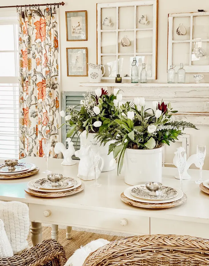 Salvaged windows with tea cups and vintage crocks flower arrangements.