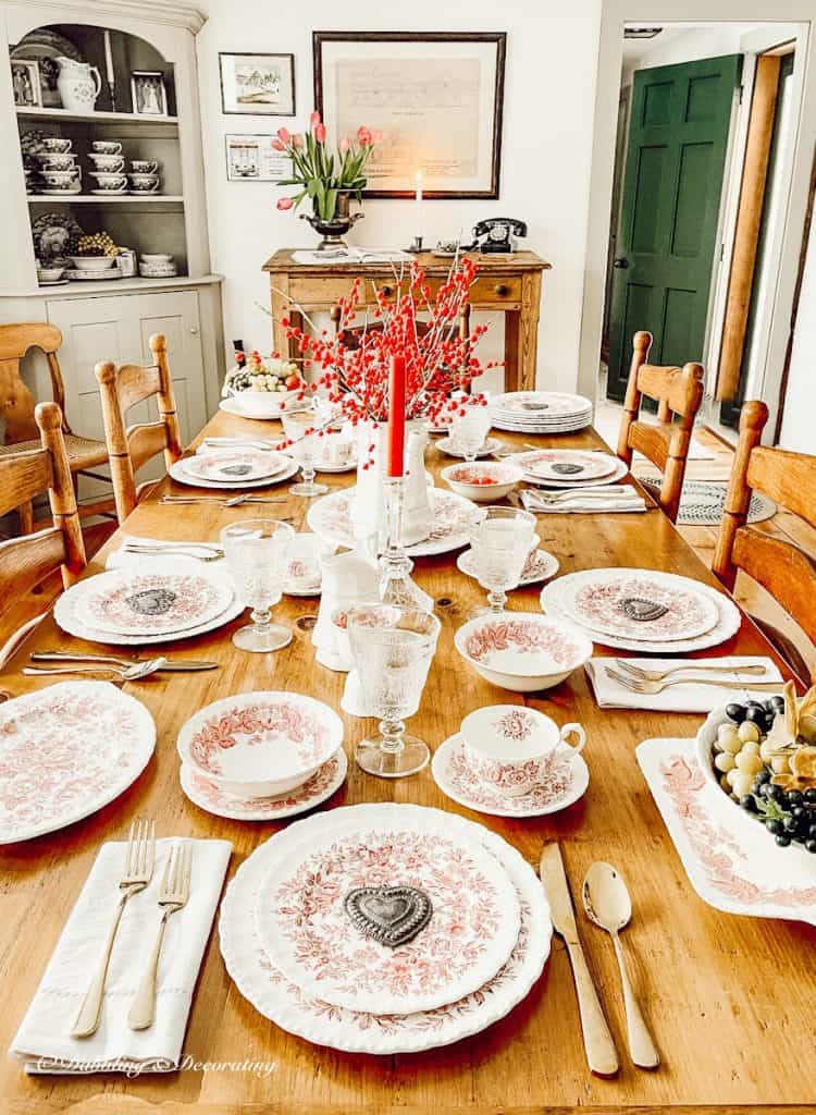 Romantic table setting pretty in pink in dining room.