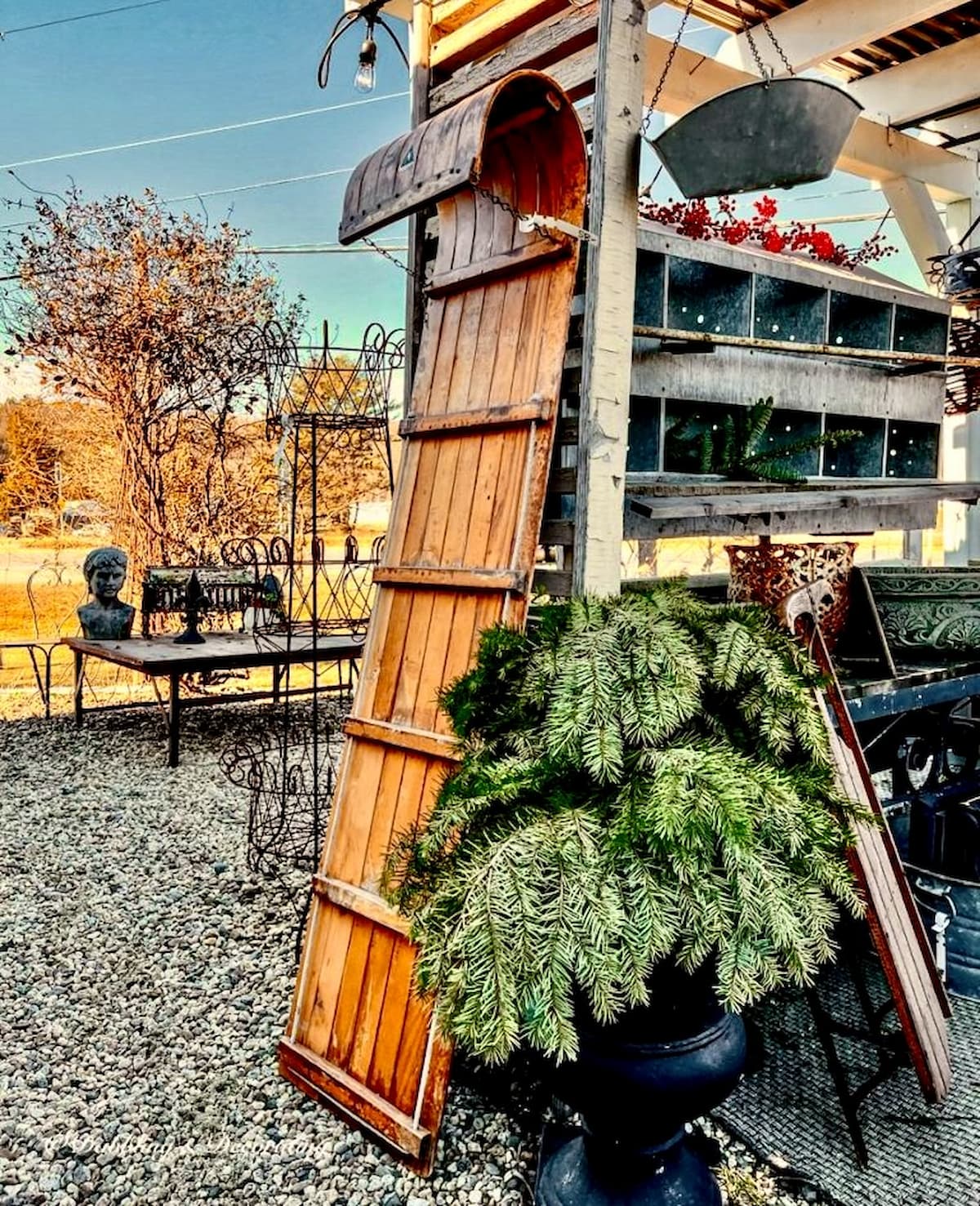How to decorate a vintage sled with a toboggan from an outdoor antique store for winter.