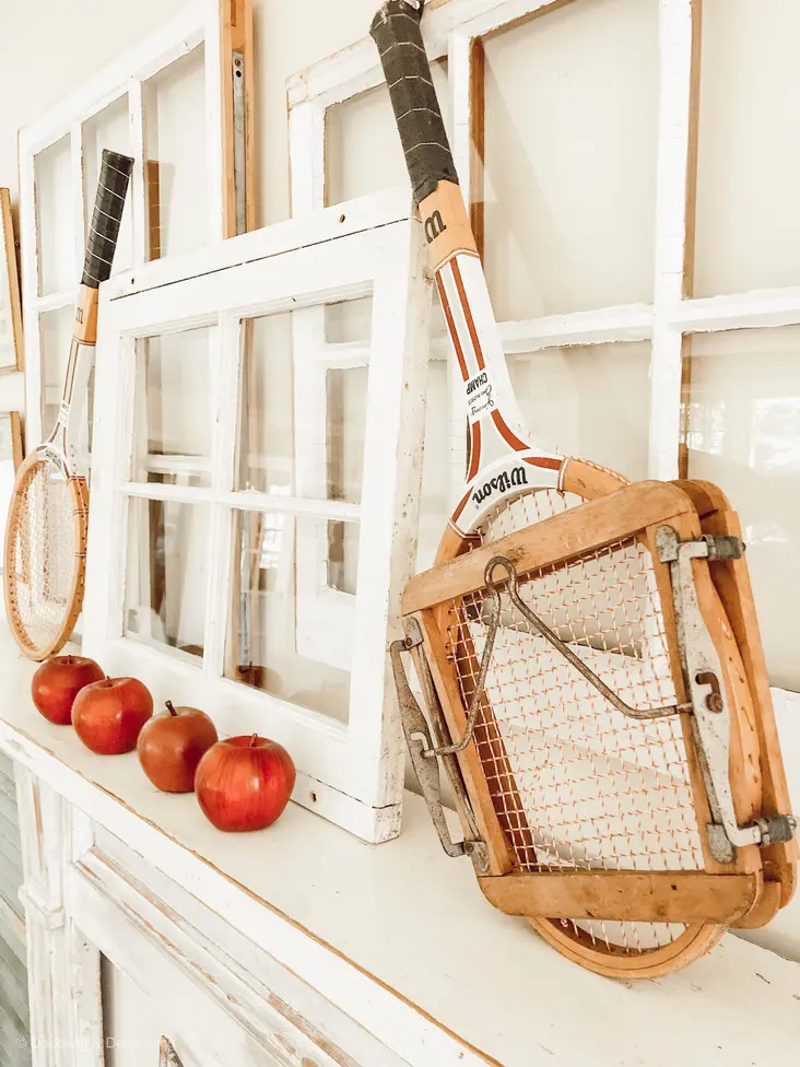 Vintage tennis racquets on vintage mantel.