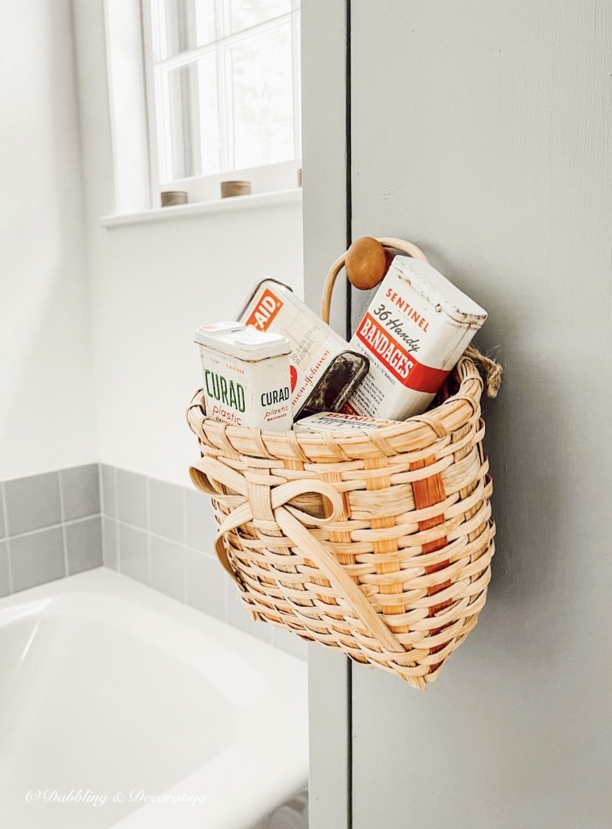Basket of vintage band-aid tins.
