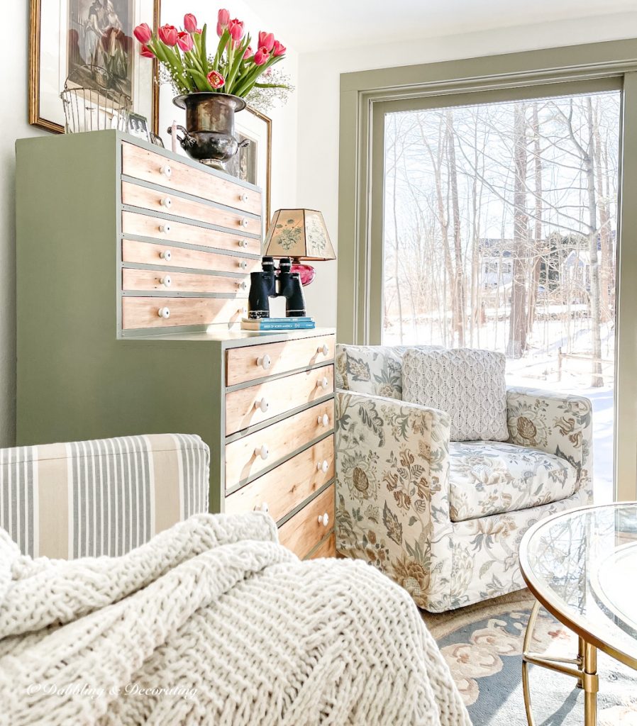 Vintage hutch decorated in sunroom.