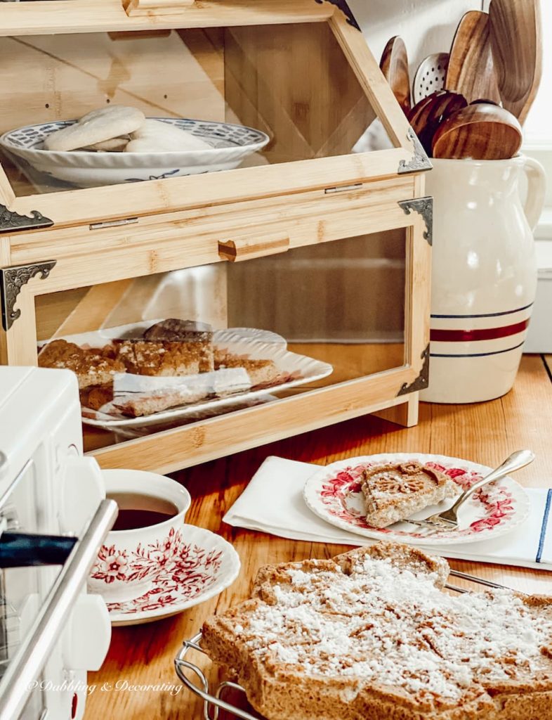 Wayfair wooden breadbox on country kitchen countertop with shortcake and tea.