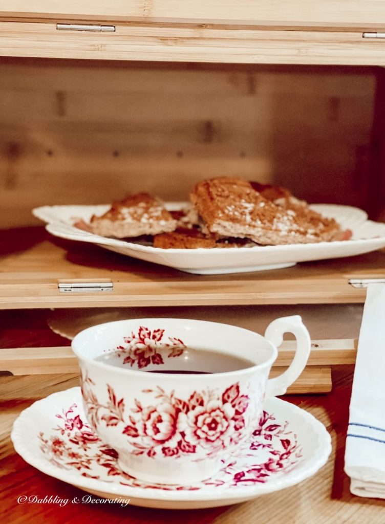 Breadbox with shortcake and cup of tea on kitchen counter