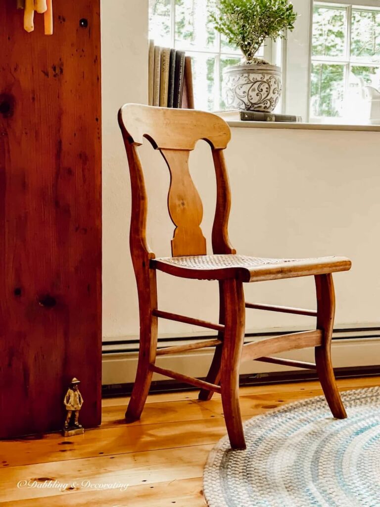 Antique chair styles, small cane chair in dining room corner.