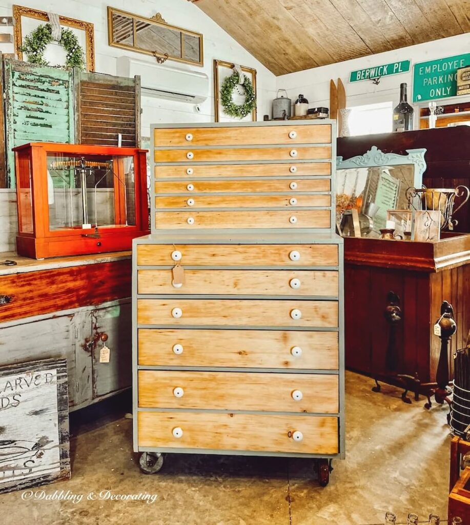 Vintage hutch styling ideas with old restored hutch with lots of drawers in antique store.