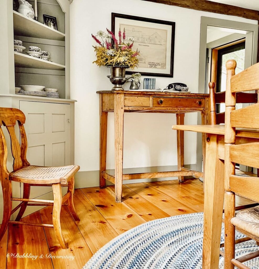 Antique chair styles, small cane chair and ladder back chair in dining room with antique desk and table.