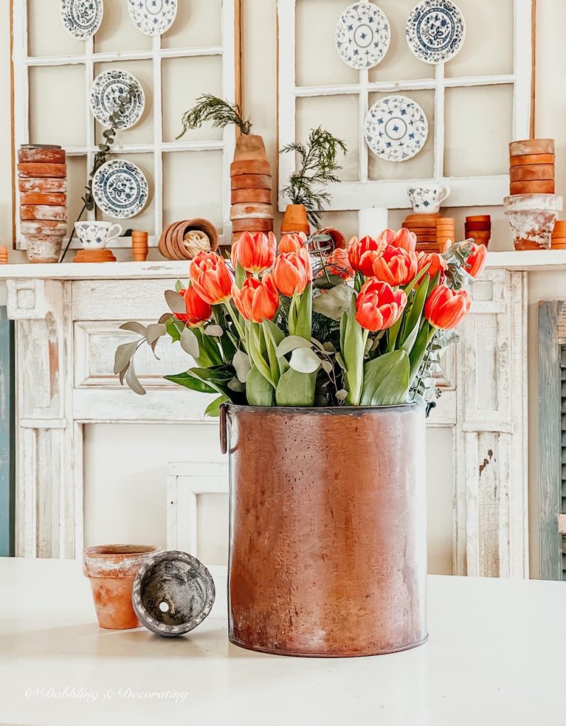 Orange Tulips in Vintage copper pot with terracotta pots.