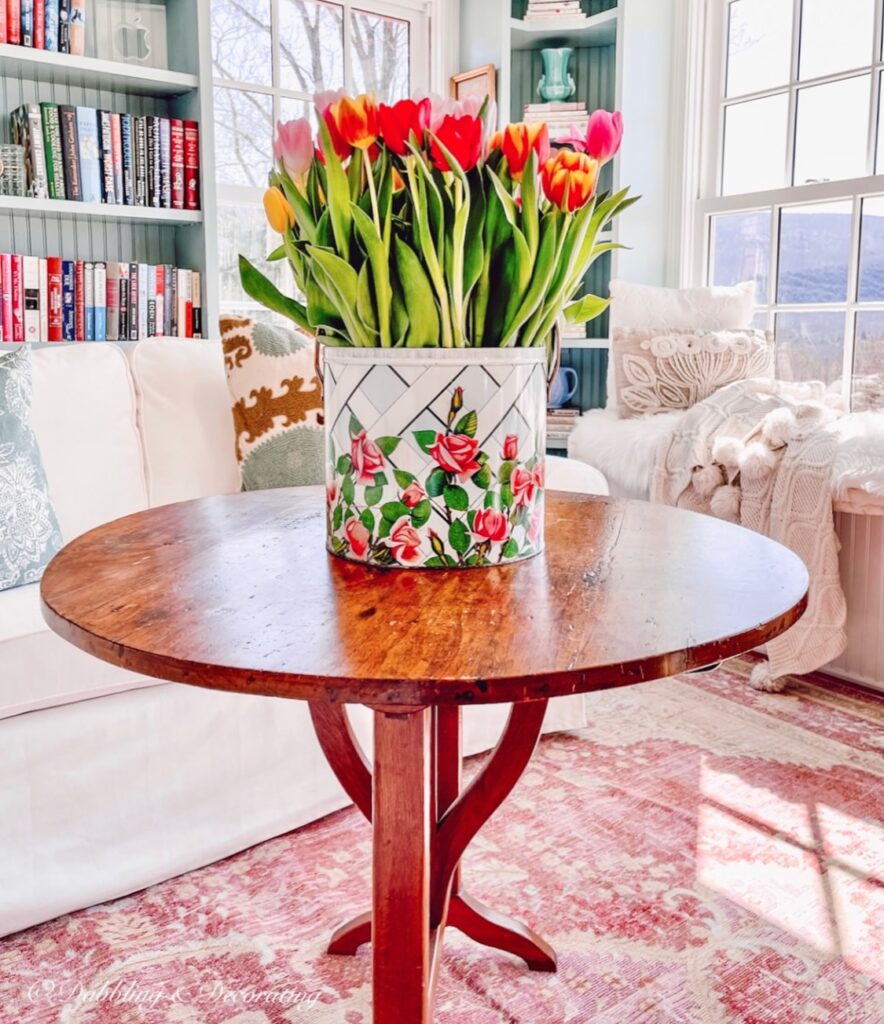 Bucket of colorful tulips in colorful craft room.