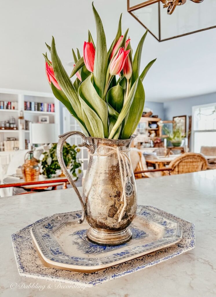 Tulip arrangement ideas in vintage silver pitchers.