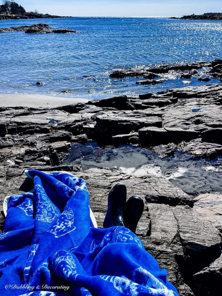 ChappyWrap blue blanket oceanside in Maine on beach.