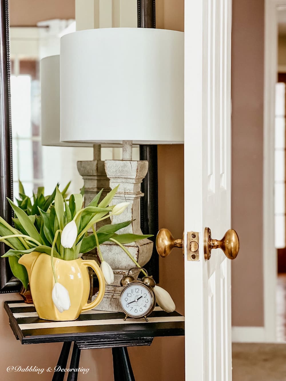 White tulip arrangement on bedroom side table with white tulips.