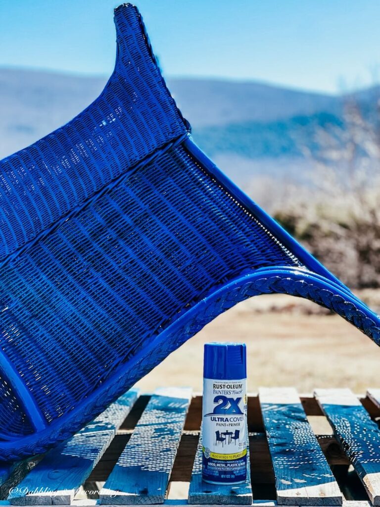 How to paint wicker furniture; a blue spray painted wicker chair with one coat of spray paint.