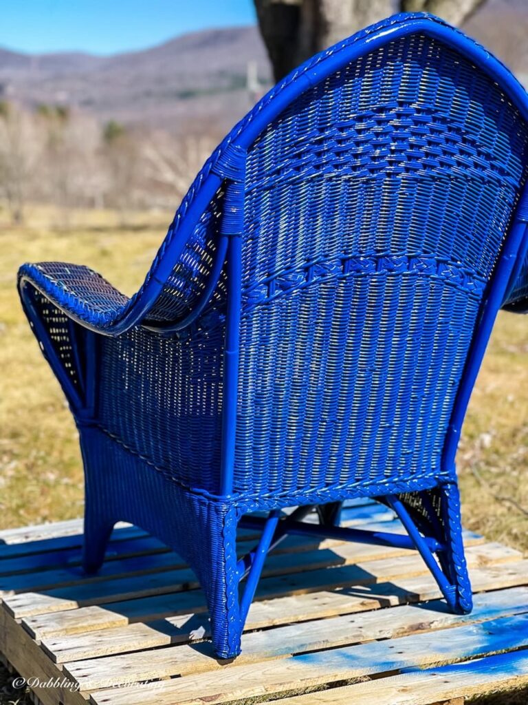 Spray painted wicker chair in cobalt blue with two coats of paint.