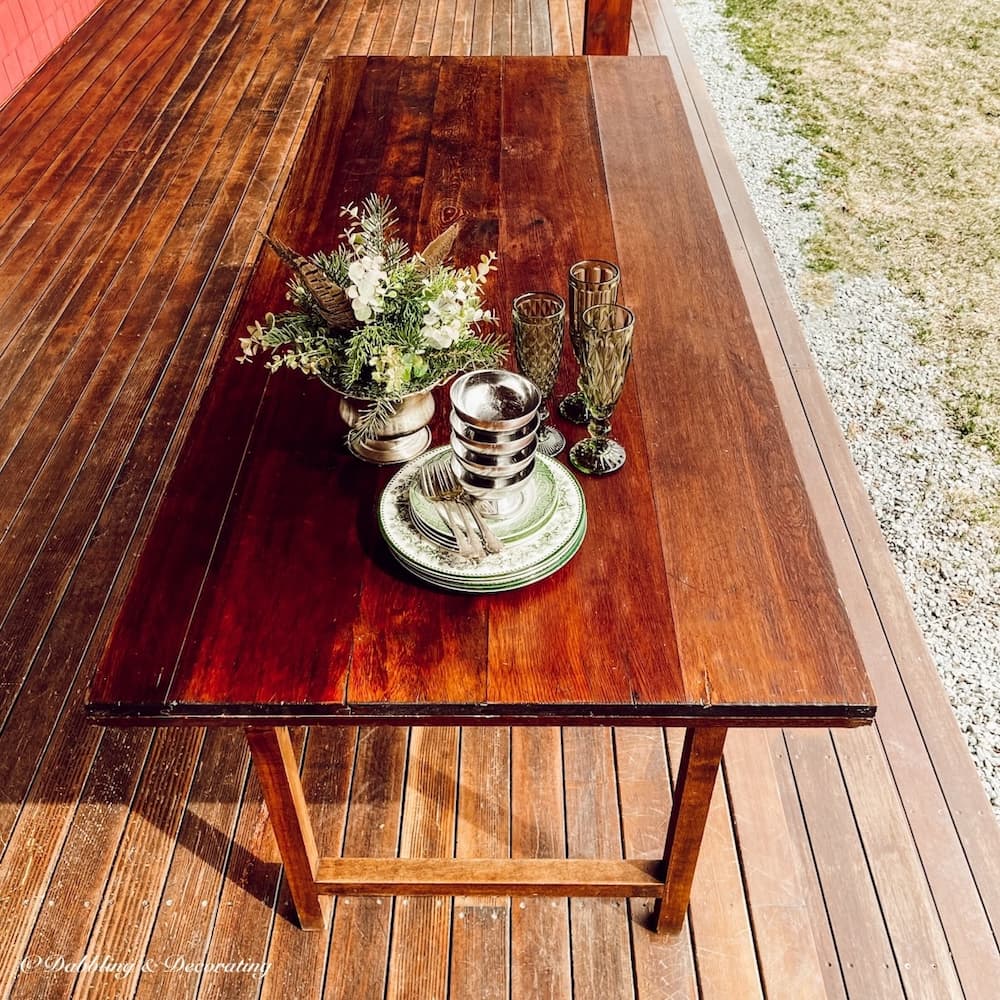 Refinished Table with dishes, glassware and centerpiece.