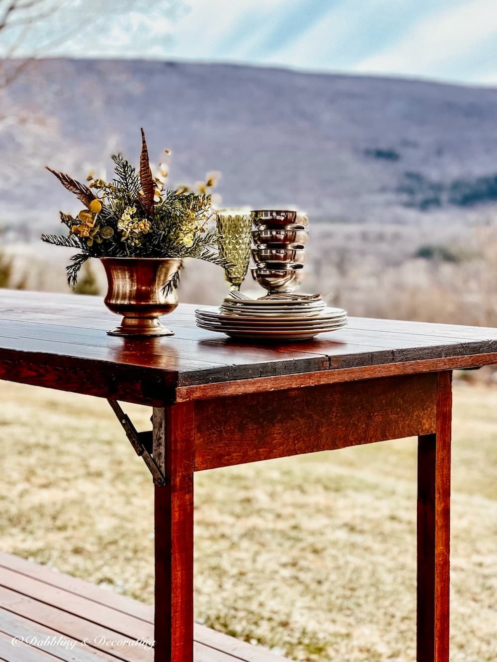 Mountain View with wooden wallpaper table and dishes.