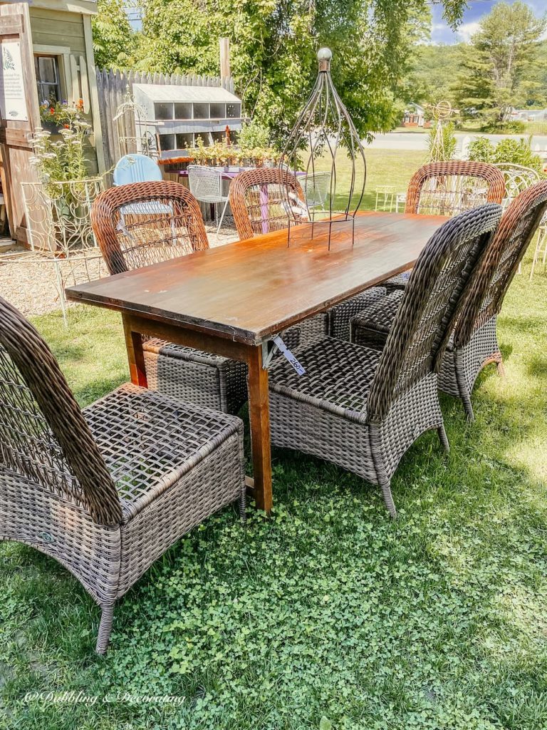 Vintage Wooden Table with Chairs at second-hand shop outdoors.