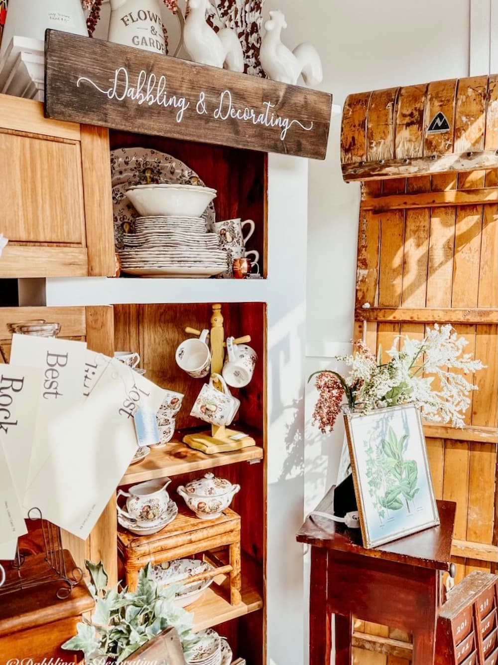 Wooden Sign with Dabbling & Decorating Logo hanging in Vintage Booth