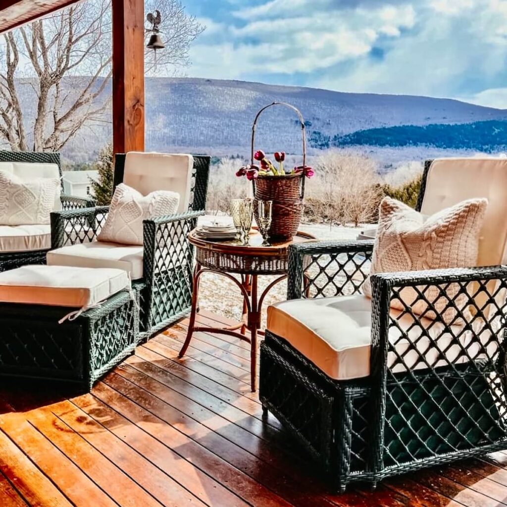 Porch furniture ideas with all weather green wicker furniture from Front Gate on covered Porch in the mountains with white cushions.