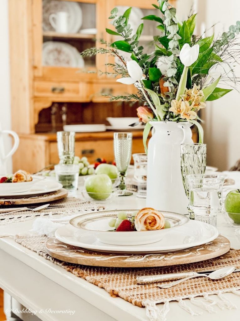 White tulip arrangement table centerpiece on farmhouse spring table.