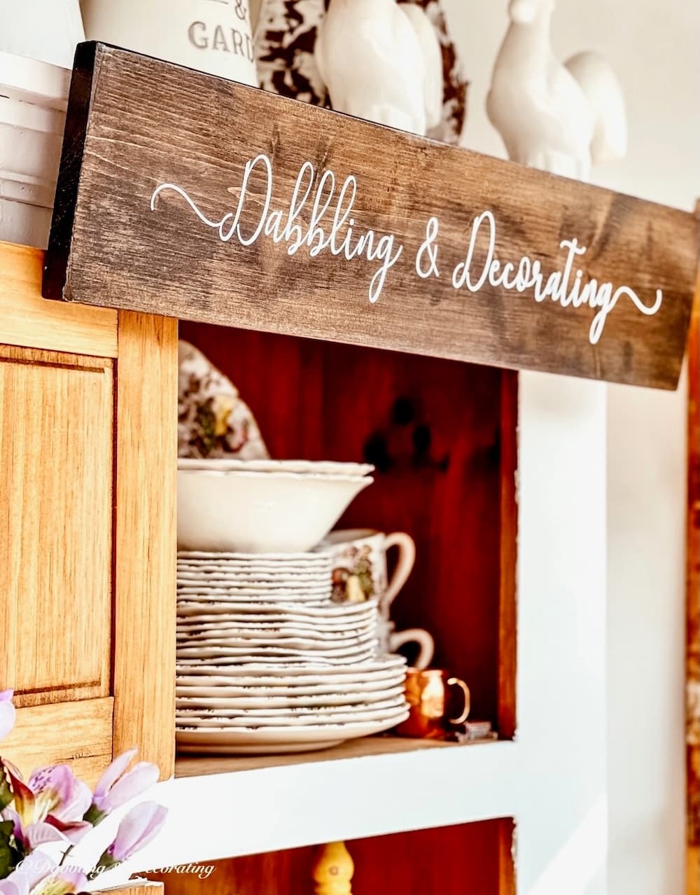 Wooden Sign with Dabbling & Decorating Logo hanging in Vintage Booth