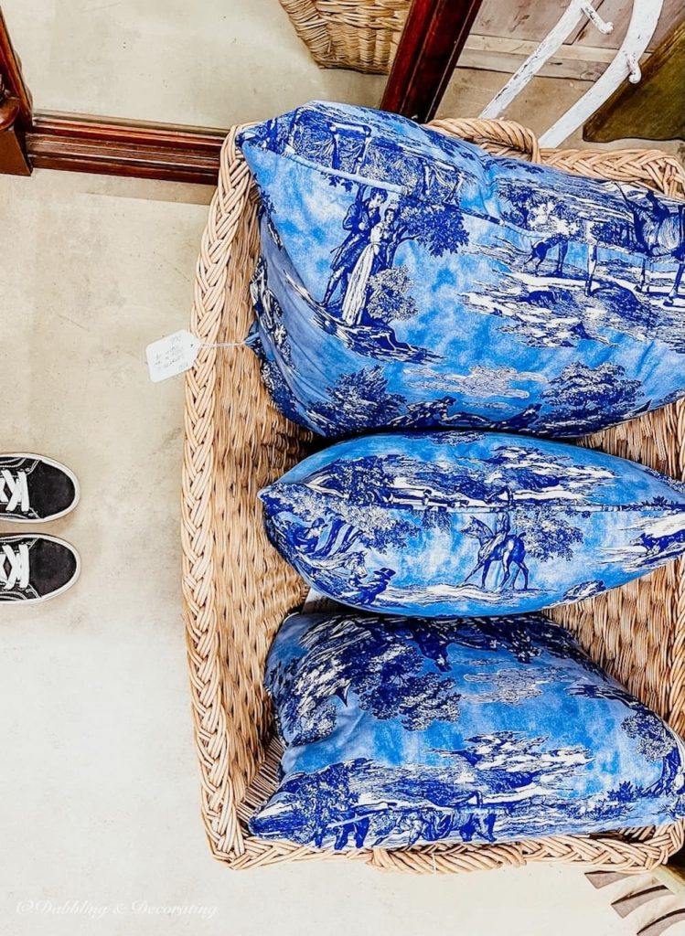 A Vintage Haul of blue and white pillows for spring porch.