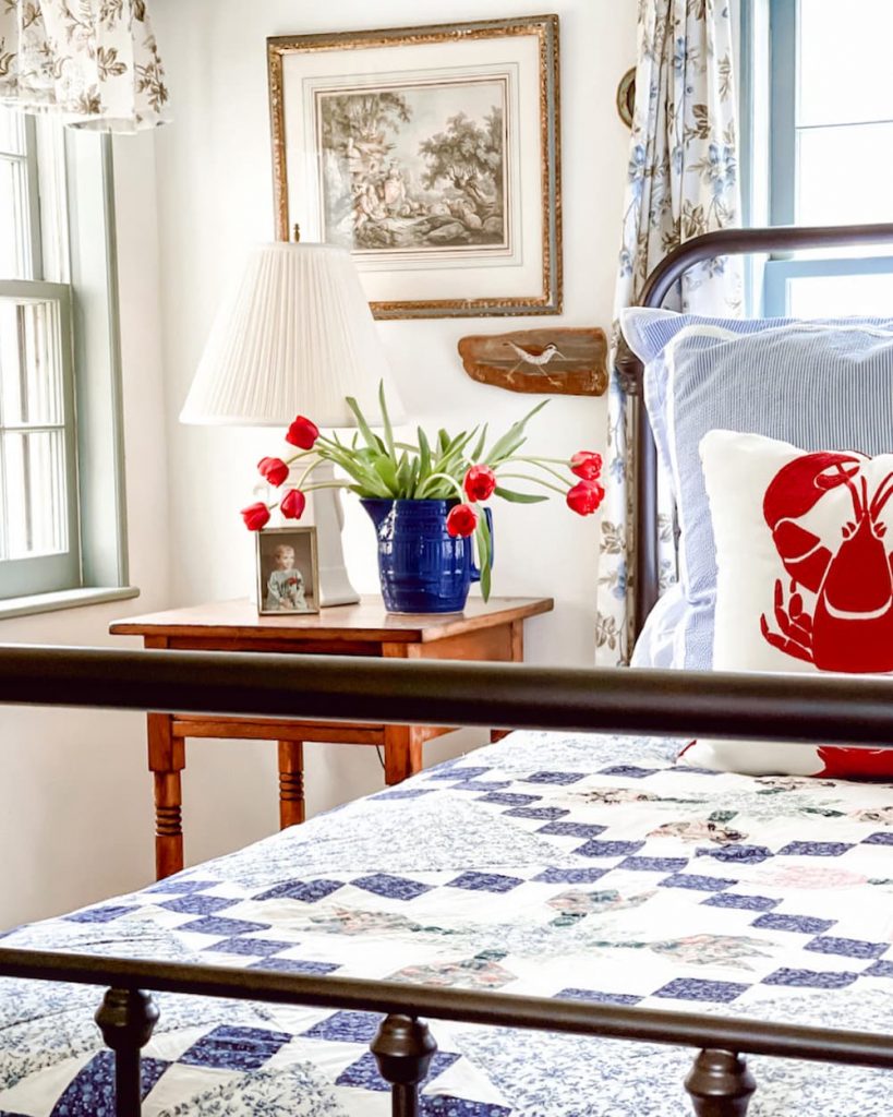 Guest Bedroom with blue pitcher and tulips on a vintage weekend retreat.