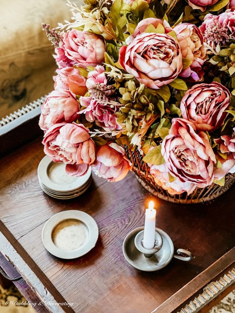 Antique Coffee Table Paired with a basket of faux peonies and antique pewter decor accents.