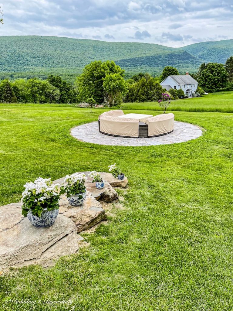 Outdoor living space in the mountains with fire pit patio and stone steps