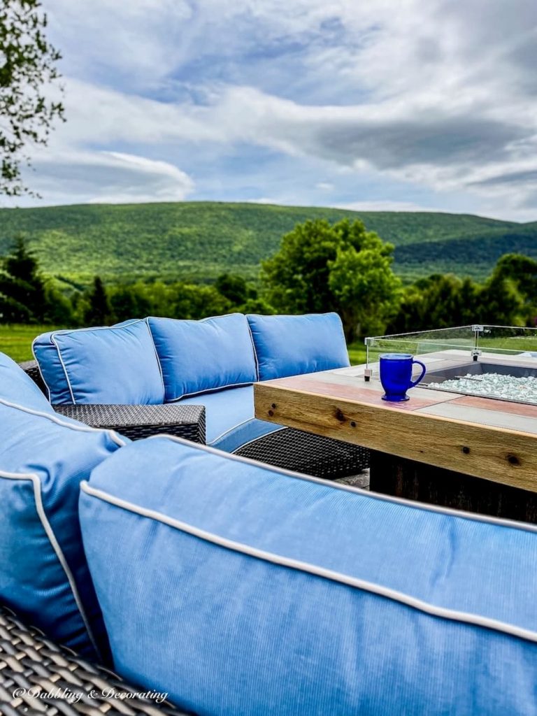 Backyard living blue furniture set with fire pit mountain views.