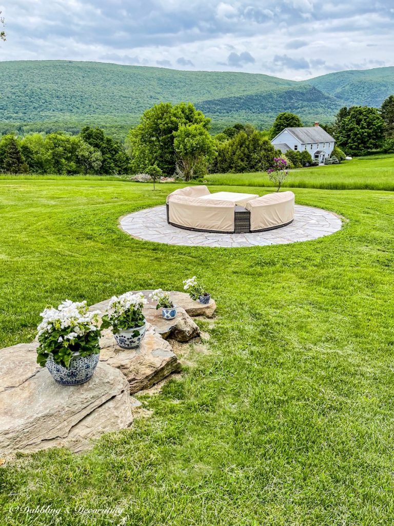 Backyard Conversation Set and Fire Pit Patio Reveal with stone steps decorated with front porch flower pots filled with white geraniums.