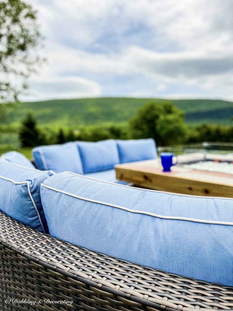 Outdoor Living Fire Pit  in the mountains with blue cushions.