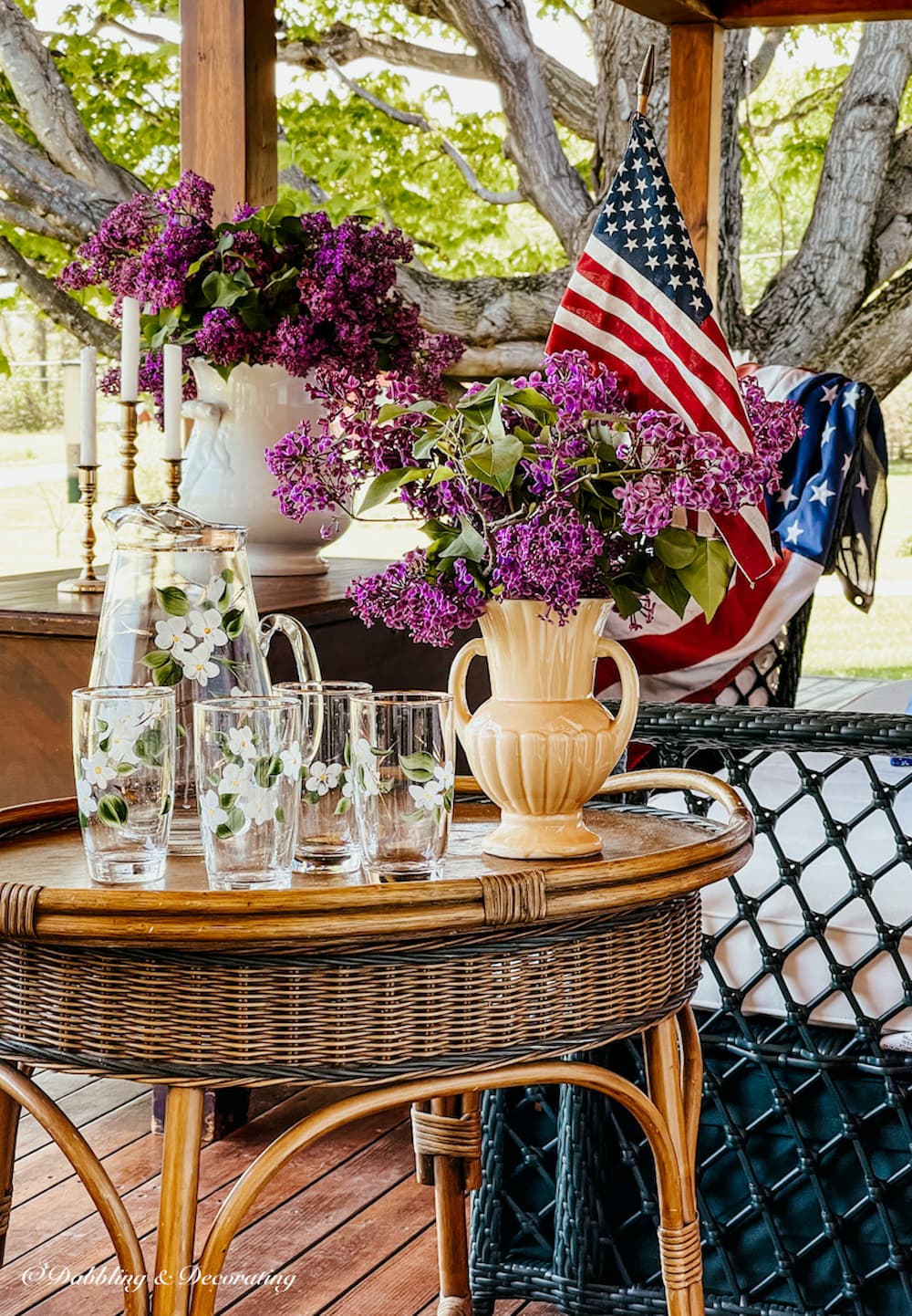 Patriotic lilac bouquets on the porch with vintage lemonade set and USA Flag.