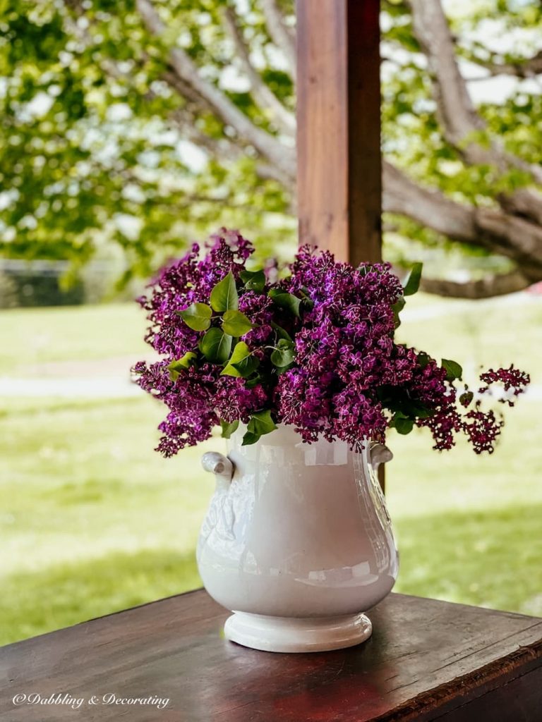 Purple flowers in Vintage White Grub Pot on the Porch.