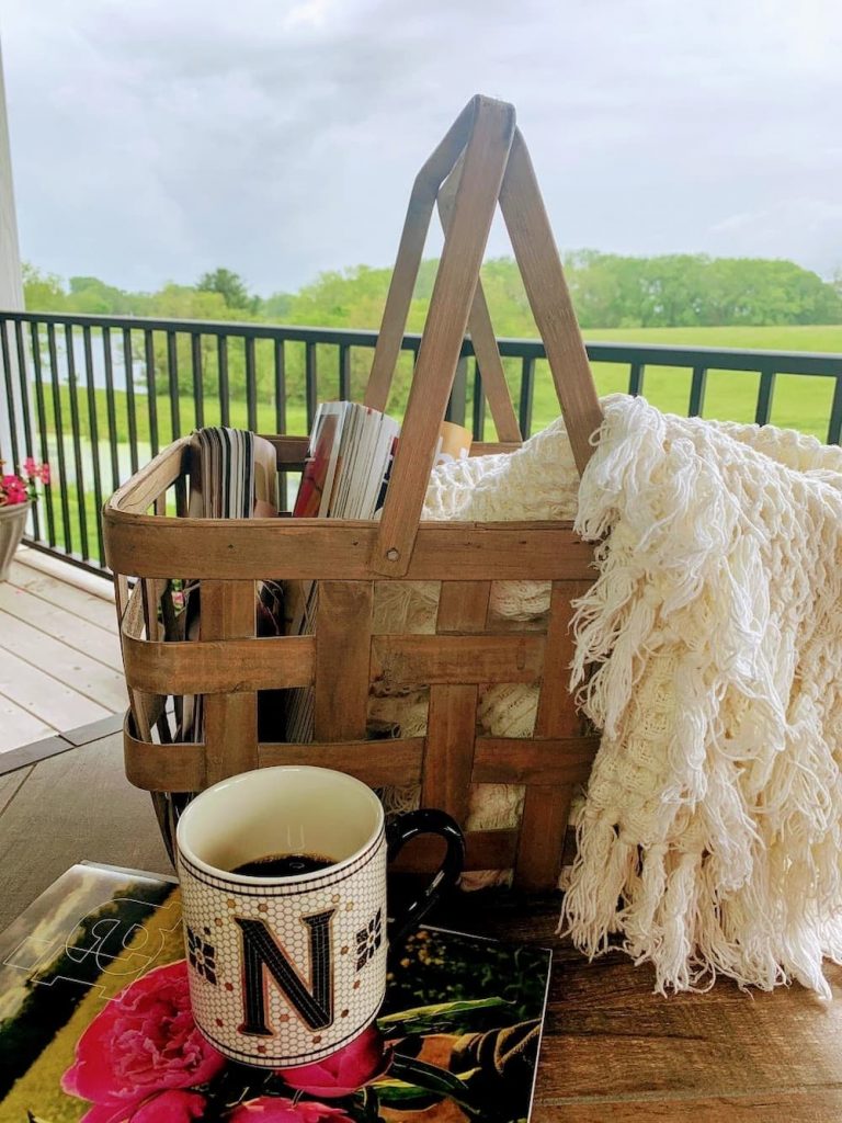 Summer vintage picnic basket with magazine and blankets.