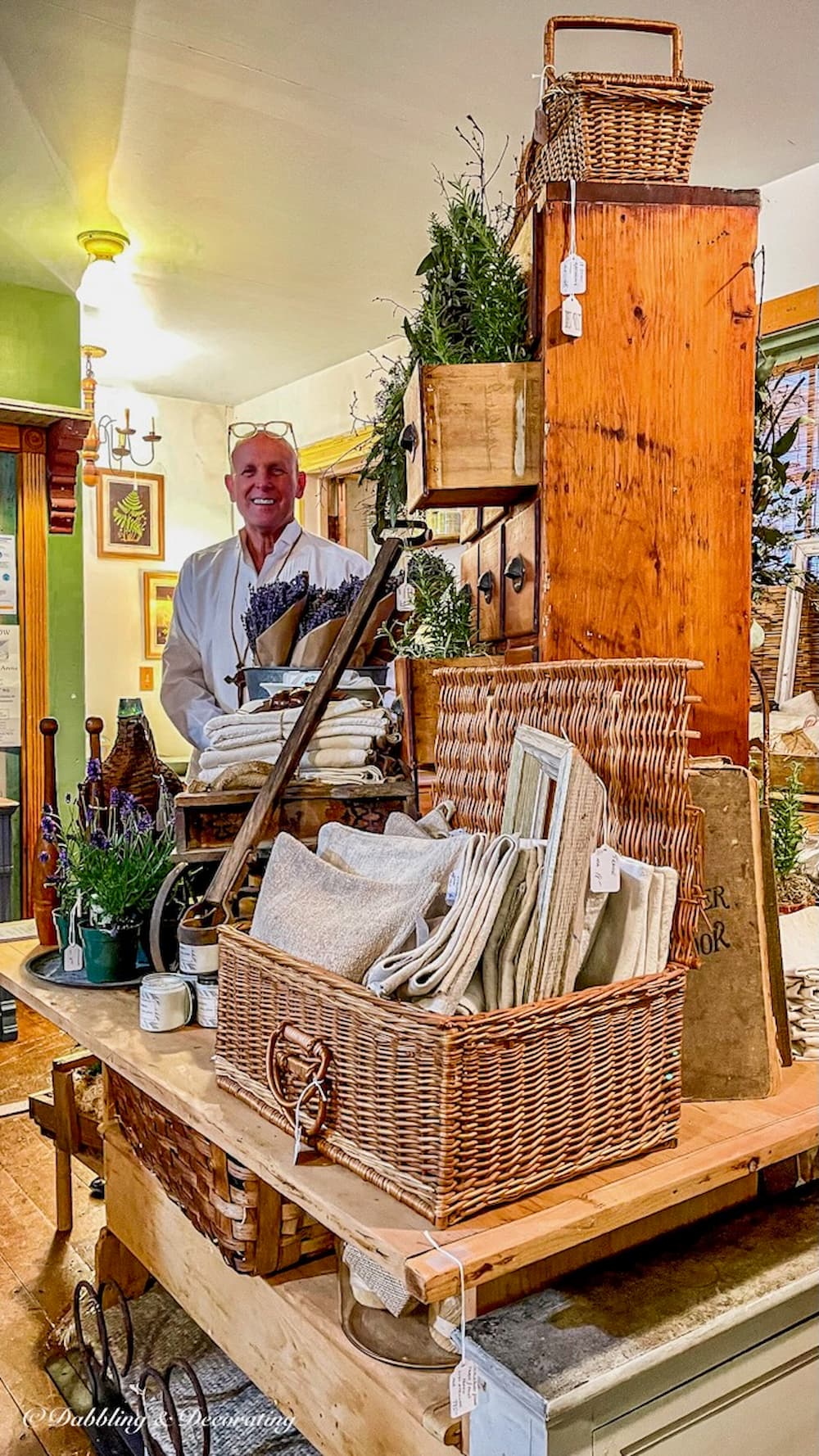 Sage Farm Antiques Early Evening buy event, The Barn at Todd Farm vendor booth with Man in Photo.