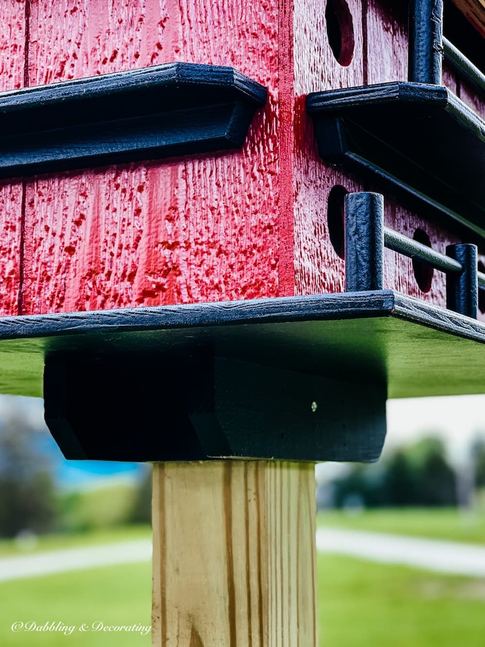 Amish birdhouse in burgundy barn red mounted.