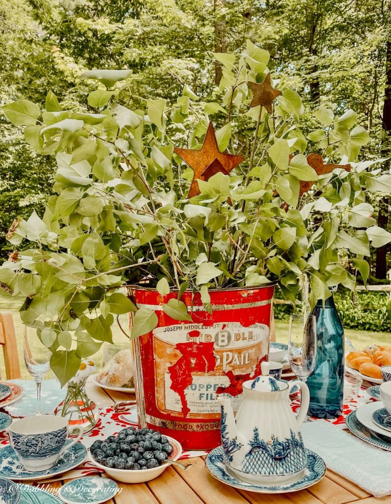 Red Bucket Outdoor Table Centerpiece with greenery.