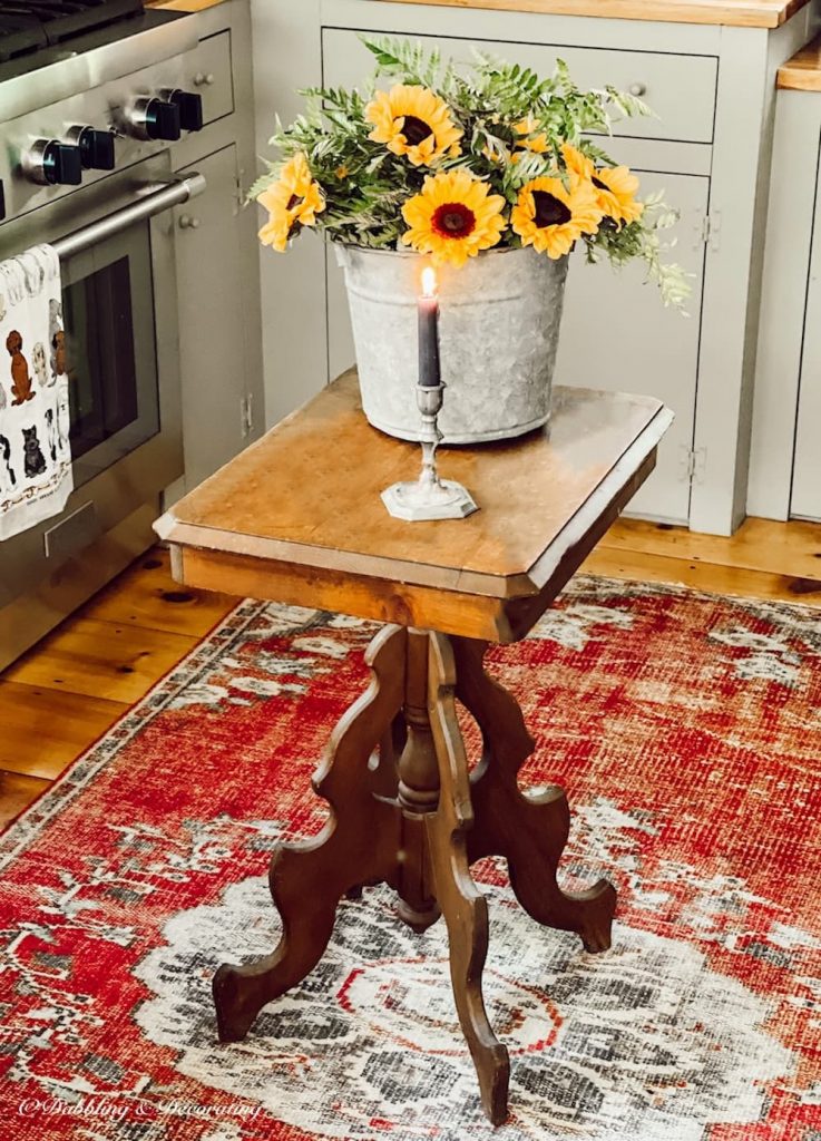 Galvanized Bucket Flower Arrangements with sunflowers on vintage table in kitchen.