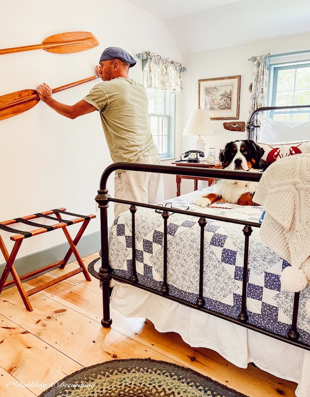 Man installing Oars on Wall.