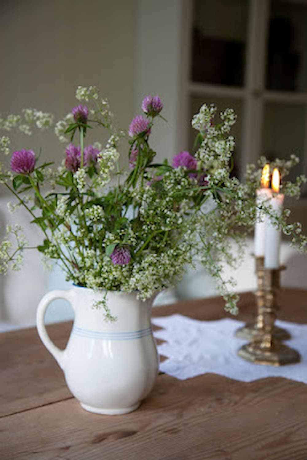 bouquet of flowers on table with candles