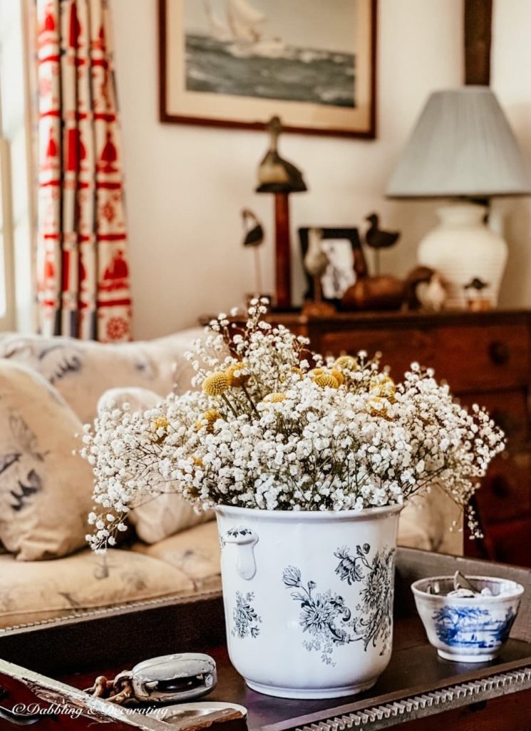 Living room coffee table with flowers in vintage style coastal Maine home.