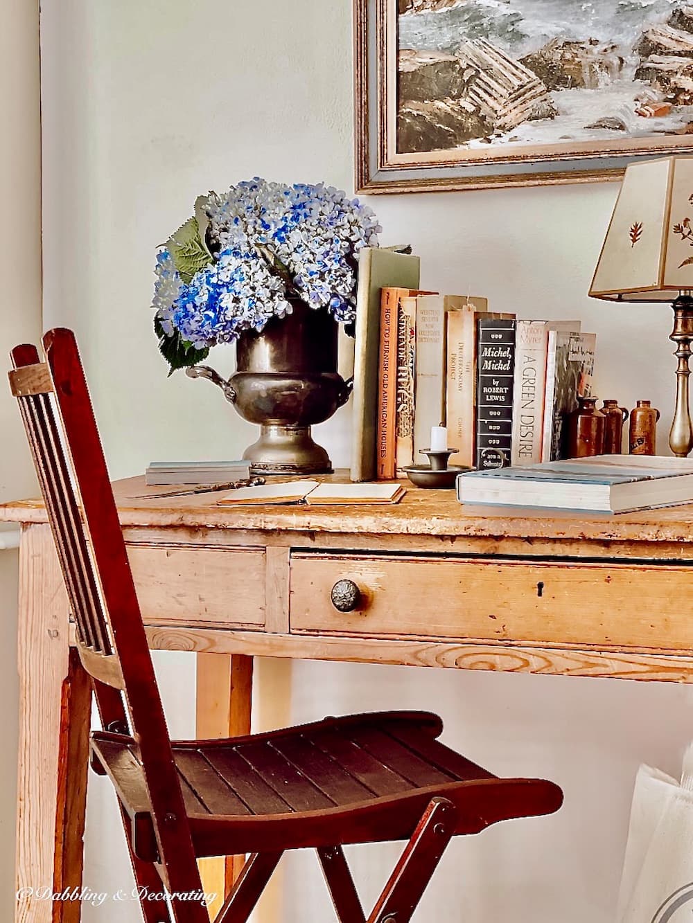 Desk with hydrangeas and vintage tennis umpire chair.