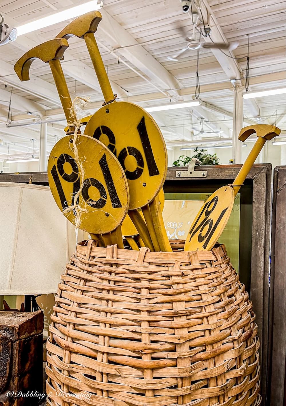 Basket filled with wooden number stakes in antique store Down East