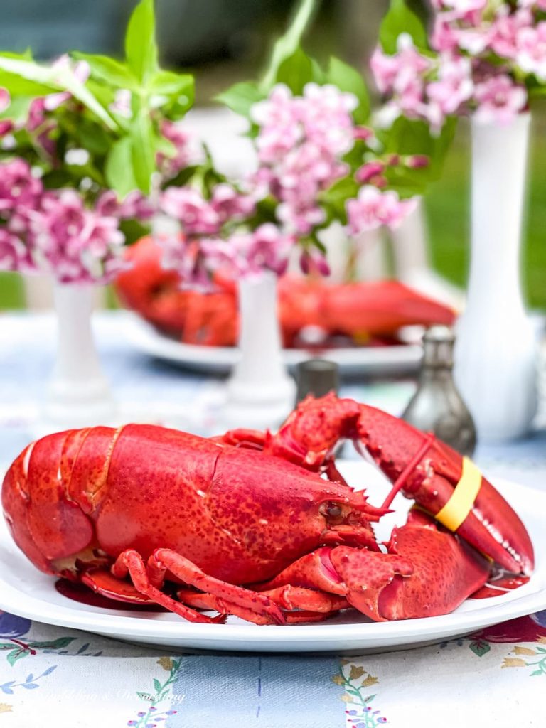 A vintage plate of lobster on a thrifty table with flowers, adding vintage charm to your home decor.